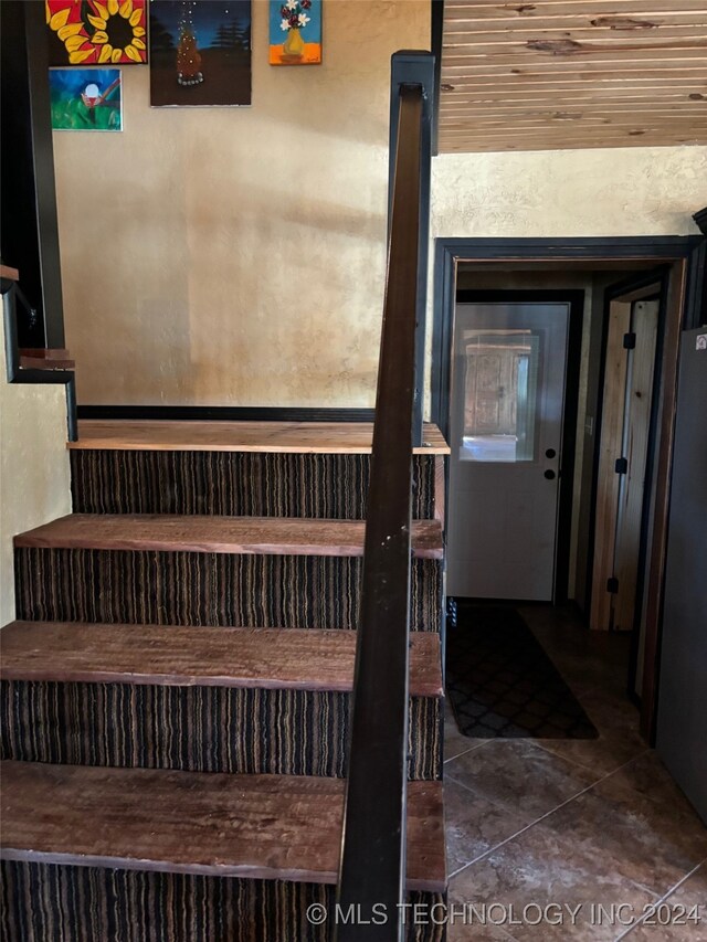 staircase with tile patterned flooring