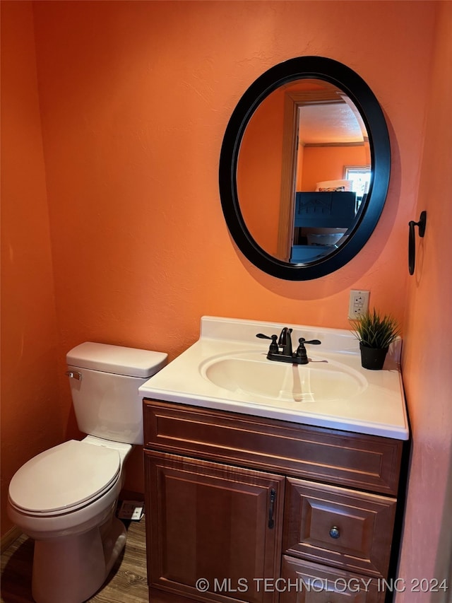 bathroom featuring hardwood / wood-style floors, toilet, and vanity