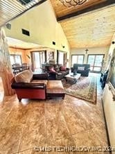 living room with high vaulted ceiling and beam ceiling