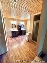 interior space with wood ceiling and hardwood / wood-style flooring