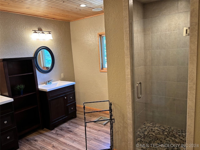 bathroom featuring vanity, hardwood / wood-style flooring, wood ceiling, and a shower with door