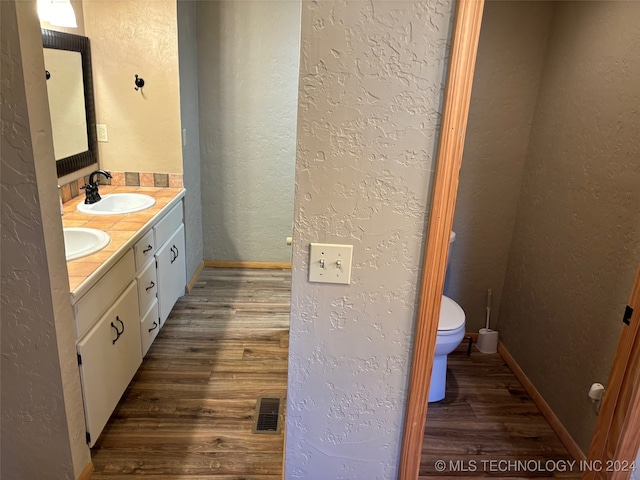 bathroom featuring vanity, toilet, and wood-type flooring