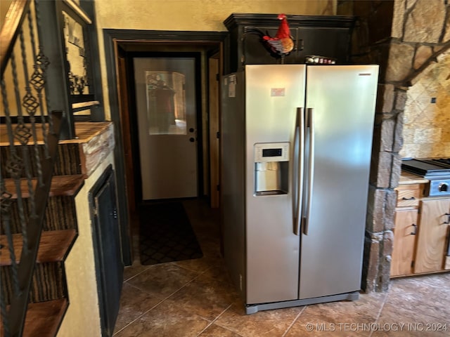 kitchen featuring a fireplace and stainless steel fridge