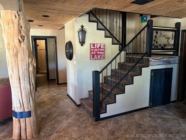 stairs with wooden ceiling