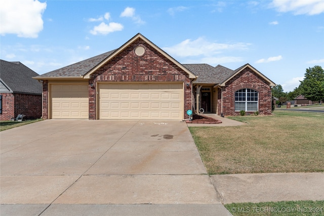 view of front facade with a front lawn and a garage