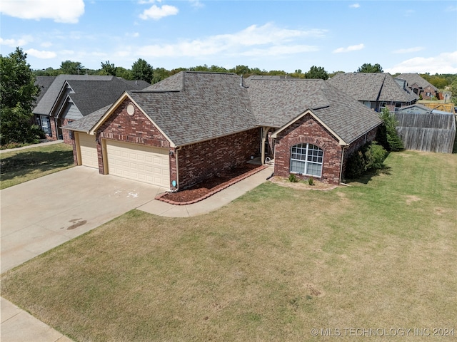 ranch-style house with a front lawn and a garage