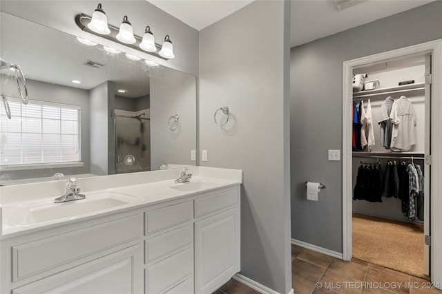 bathroom with vanity, tile patterned floors, and a shower with door