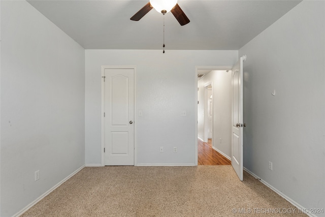 unfurnished bedroom with light carpet and ceiling fan