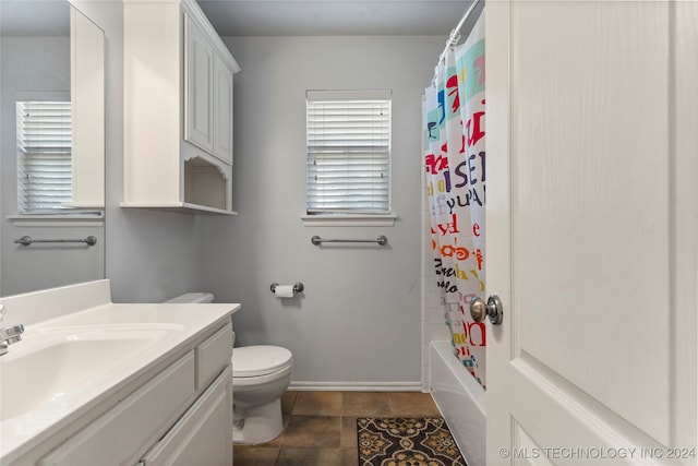 full bathroom featuring vanity, toilet, tile patterned flooring, and shower / bathtub combination with curtain