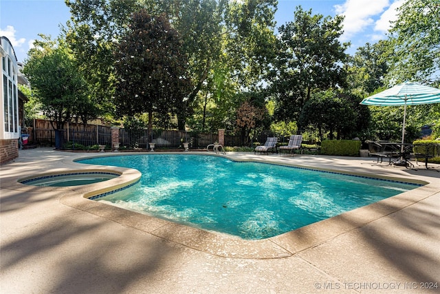 view of swimming pool featuring an in ground hot tub and a patio