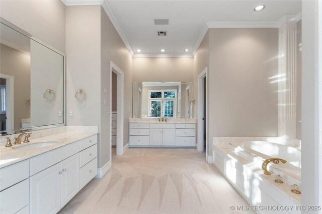 bathroom with crown molding, vanity, and a bathing tub