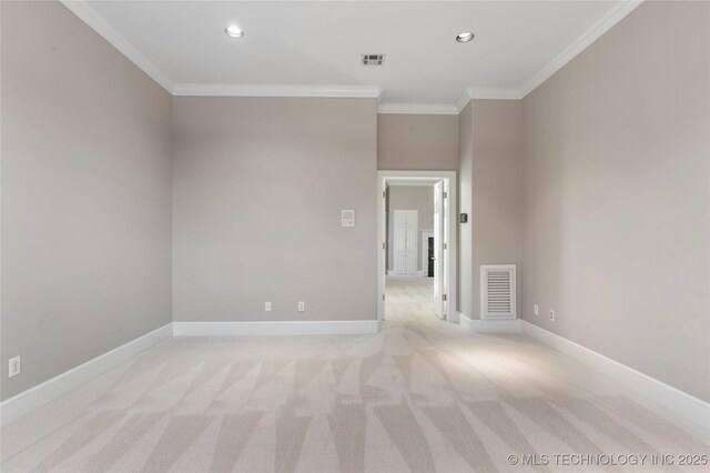 carpeted empty room featuring crown molding