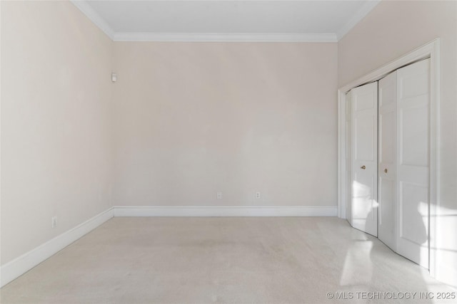 unfurnished bedroom with ornamental molding, light carpet, and a closet