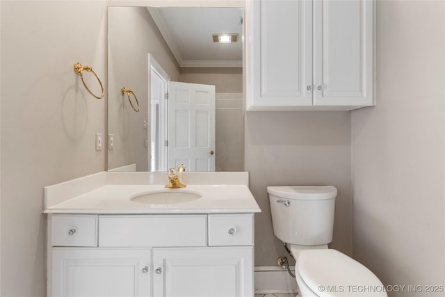 bathroom with vanity, ornamental molding, and toilet