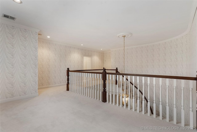 hallway with crown molding and carpet flooring