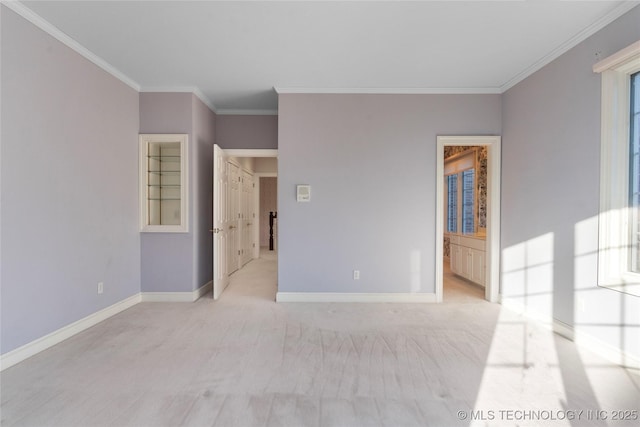 spare room with crown molding and light colored carpet