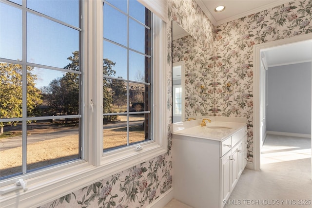 bathroom with ornamental molding, vanity, and plenty of natural light