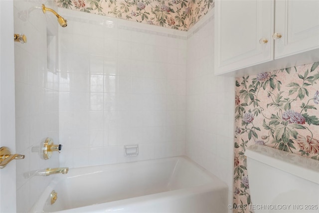 bathroom featuring bathing tub / shower combination and toilet