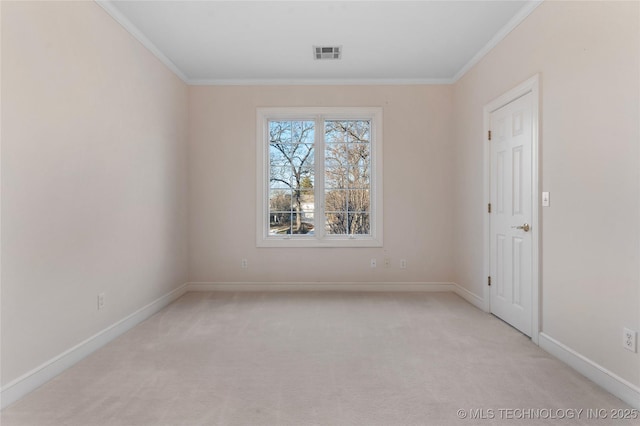 carpeted spare room featuring crown molding