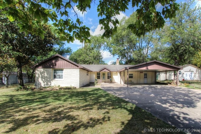 single story home with a front lawn and a carport