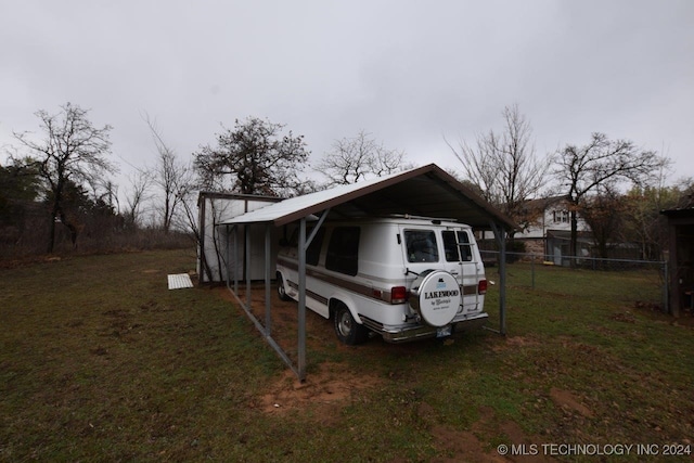 view of side of home featuring a yard and a carport