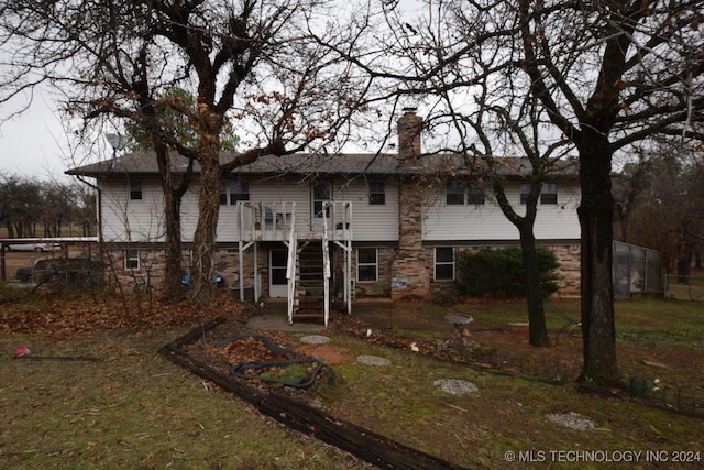 rear view of house with a wooden deck