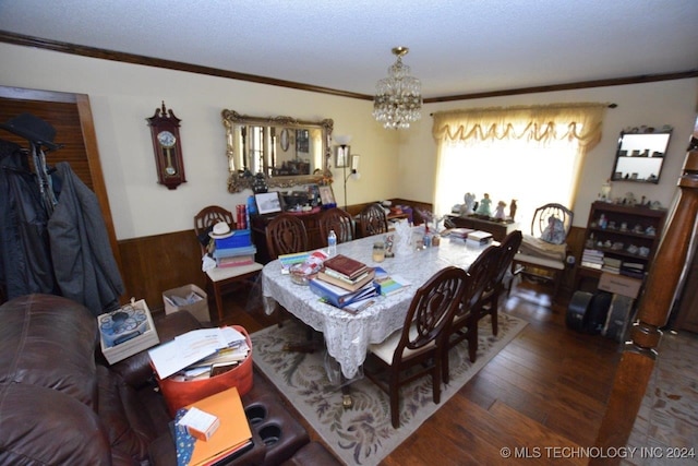 dining space featuring an inviting chandelier, dark hardwood / wood-style flooring, crown molding, and a textured ceiling