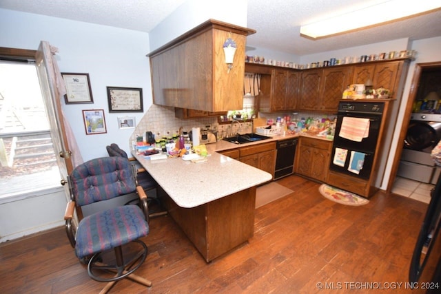 kitchen featuring dishwasher, dark wood-type flooring, kitchen peninsula, and sink