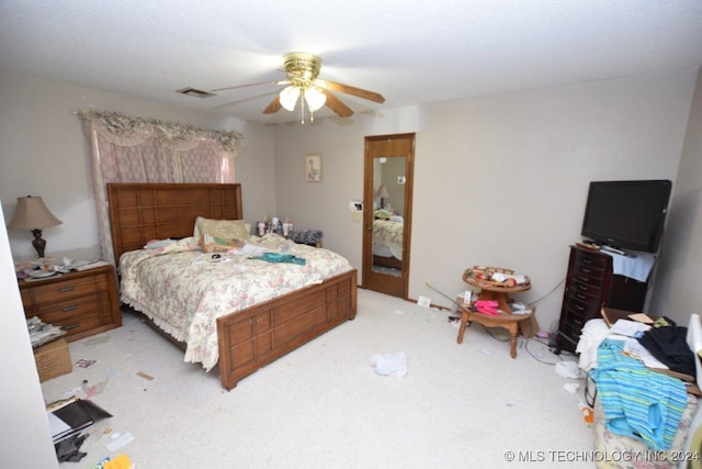 bedroom with light carpet and ceiling fan