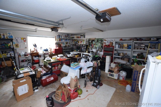 garage with a garage door opener and a workshop area