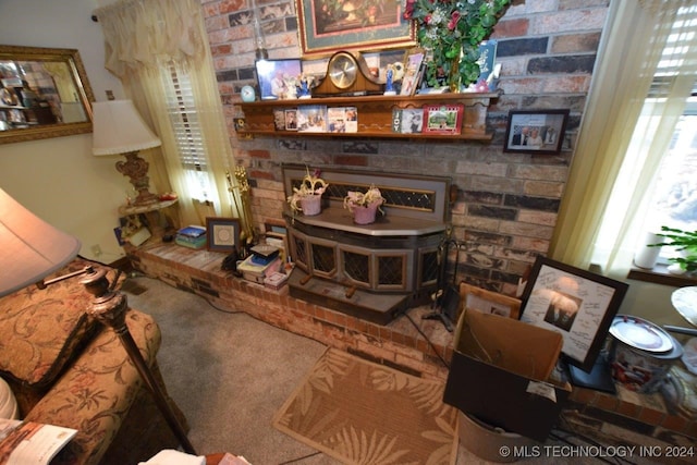 carpeted living room featuring a brick fireplace