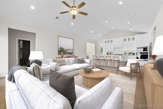 living room featuring high vaulted ceiling, ceiling fan, and light hardwood / wood-style floors