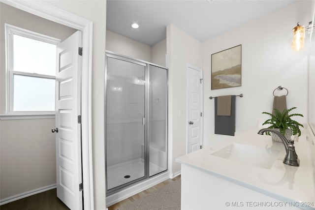 bathroom featuring vanity and an enclosed shower