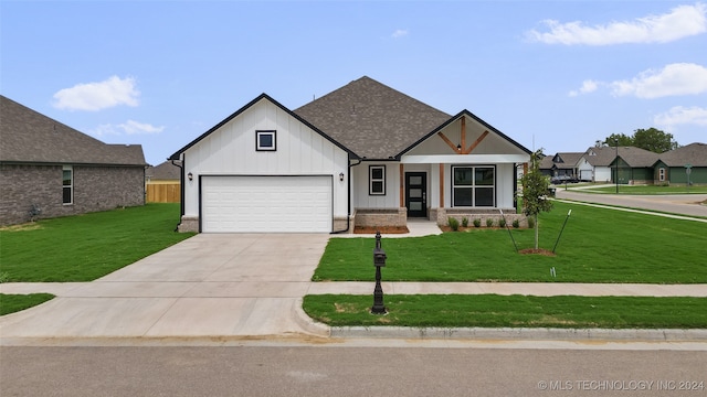 view of front facade with a garage and a front lawn