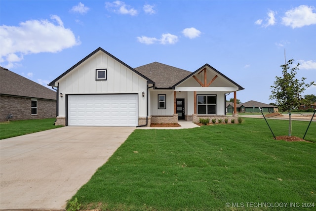 view of front of home featuring a garage and a front lawn