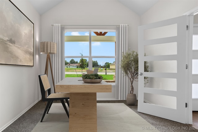 home office with lofted ceiling and carpet flooring