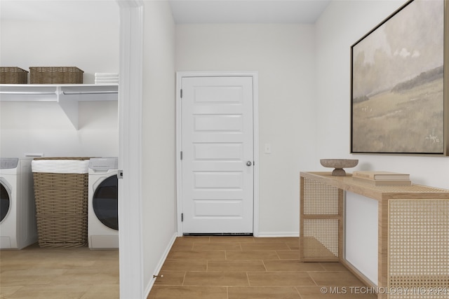 laundry area with washer / dryer and light hardwood / wood-style floors