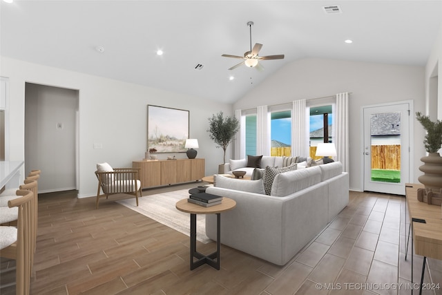 living room with lofted ceiling, ceiling fan, and light hardwood / wood-style floors