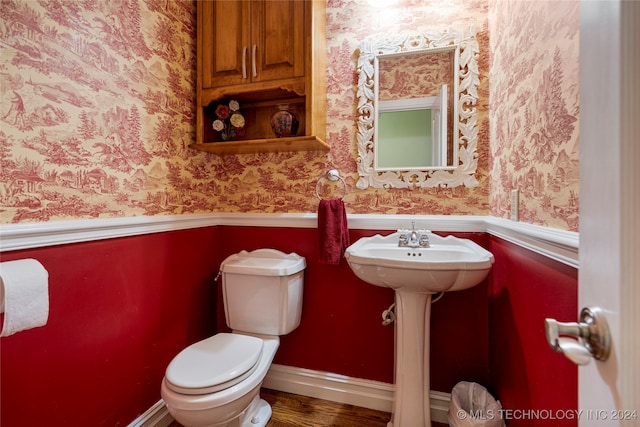 bathroom with toilet and hardwood / wood-style flooring