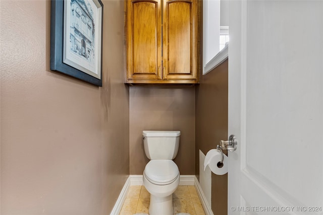 bathroom featuring toilet and tile patterned floors