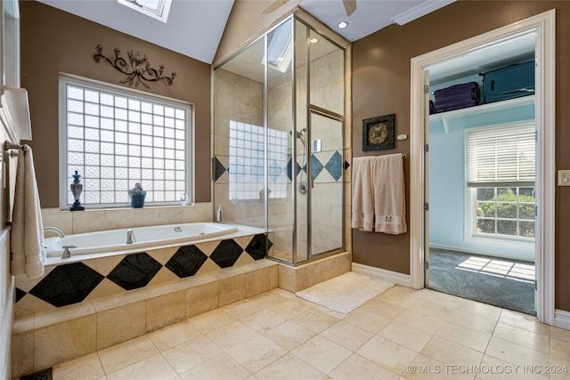 bathroom with separate shower and tub, tile patterned floors, and lofted ceiling with skylight