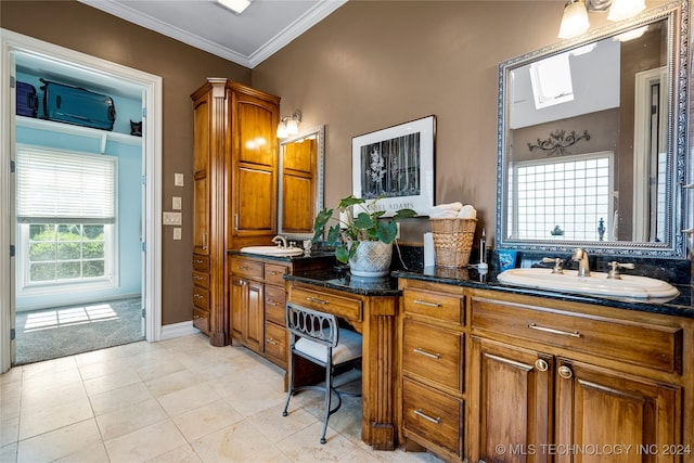 bathroom featuring a wealth of natural light, vanity, tile patterned floors, and a skylight