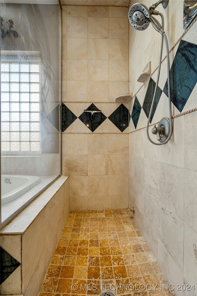 bathroom featuring shower with separate bathtub