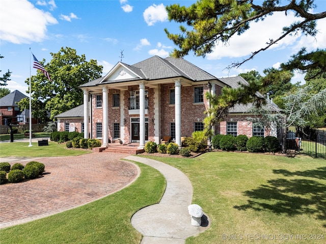 greek revival house featuring a front lawn