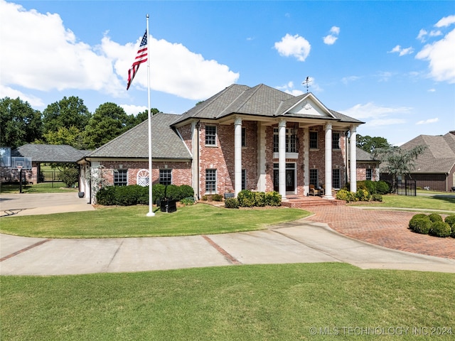 neoclassical / greek revival house with covered porch and a front yard