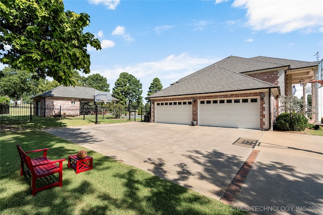 exterior space with a garage and a front lawn