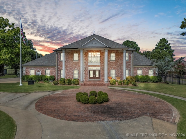 greek revival house with a lawn