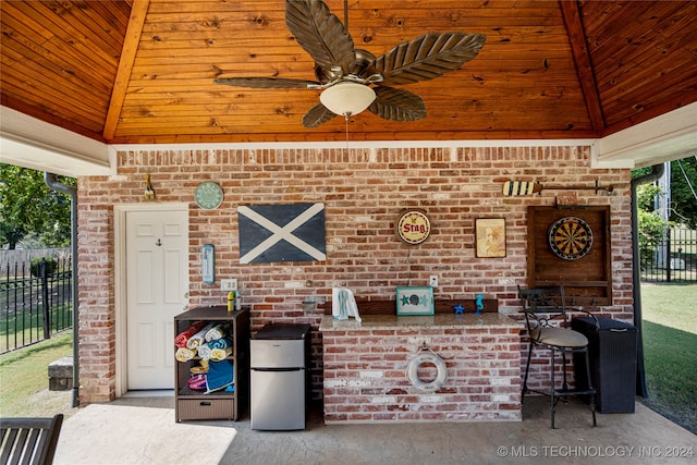 view of patio / terrace with exterior bar and ceiling fan