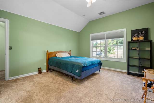 carpeted bedroom with ceiling fan and vaulted ceiling