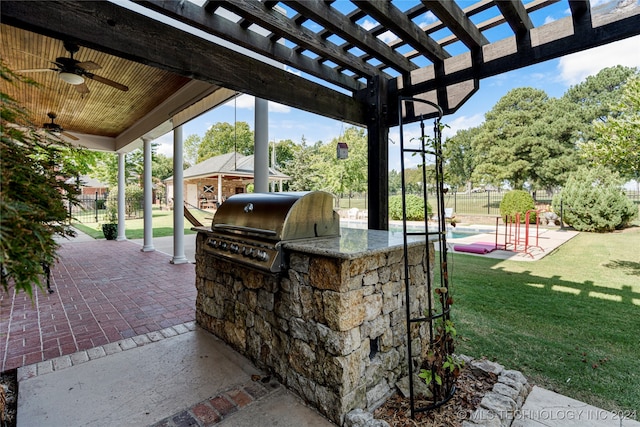 view of patio with a grill, ceiling fan, area for grilling, and a pergola